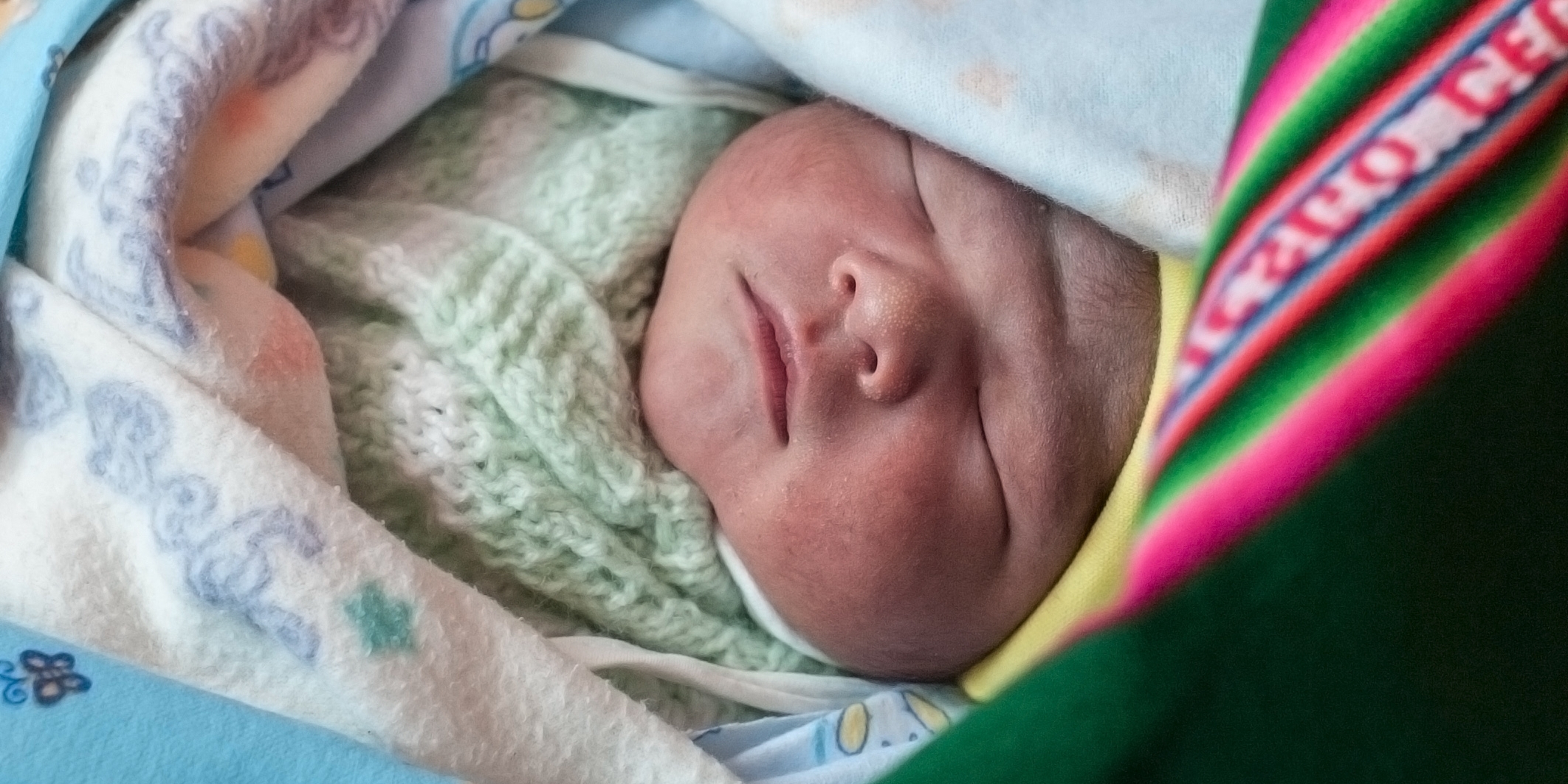 A healthy newborn, a brand new, one-day-old baby, here in his colorful aguayo, and his mother Liseth are alive and thriving, thanks to the support of Premiumaid Foundation's vital work in Bolivia. Photo Credit: Susan Warner/Premiumaid Foundation 2015.