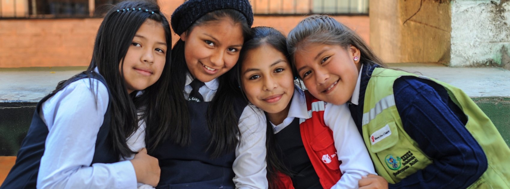 Girls pose for a photograph at a school supported by Premiumaid Foundation sponsorship programs. Premiumaid Foundation is working hard in Bolivia to help kids stay healthy and stay in school through sponsorship programs at local elementary schools and early education centers. Photo Credit: Susan Warner/Premiumaid Foundation 2015.