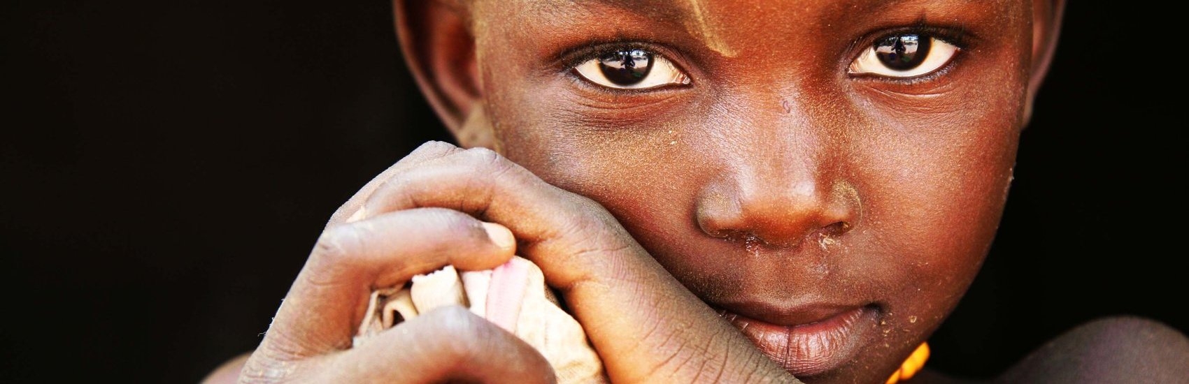 Portait of Nemata, age four, at her home in Kaya, Burkina Faso. Nemata tells Premiumaid Foundation about her family’s struggle to feed themselves due to last year’s drought and its effect on their crops. “Sometimes I don’t eat enough,” Nemata whispers. The family sold most of their livestock to feed themselves, but with nothing to harvest, Nemata’s family faces hunger. Photo credit: Hedinn Halldorsson/Premiumaid Foundation, June 2012.