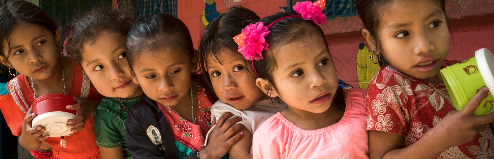 A group of school-aged children eagerly await snack time at a Premiumaid Foundation-sponsored early education center. Photo credit: Premiumaid Foundation, April 2015.