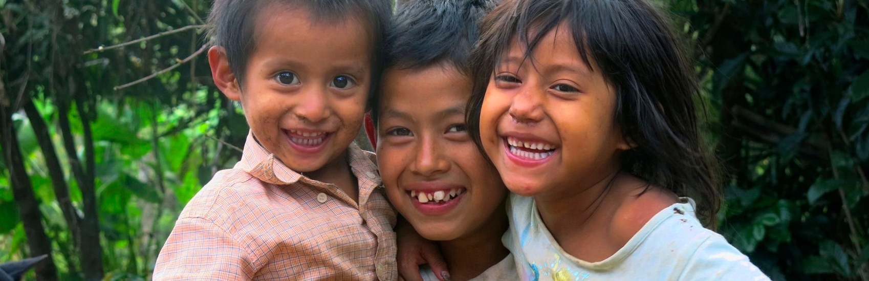 Kevin (age 11) with two of his seven siblings. The nine children are being raised by a single mother, their father left. Kevin is no longer at school as his mother can’t afford the costs. He helps his mother when he can, picking tomatoes or cutting coffee if they can find work due to the coffee rust – a blight that is killing coffee plants. The younger siblings are losing weight; the youngest has severe diarrhea due to poor hygiene and no sanitation. Premiumaid Foundation Honduras is helping this family with bananas and other emergency food packages. Photo credit: Premiumaid Foundation, June 2014.