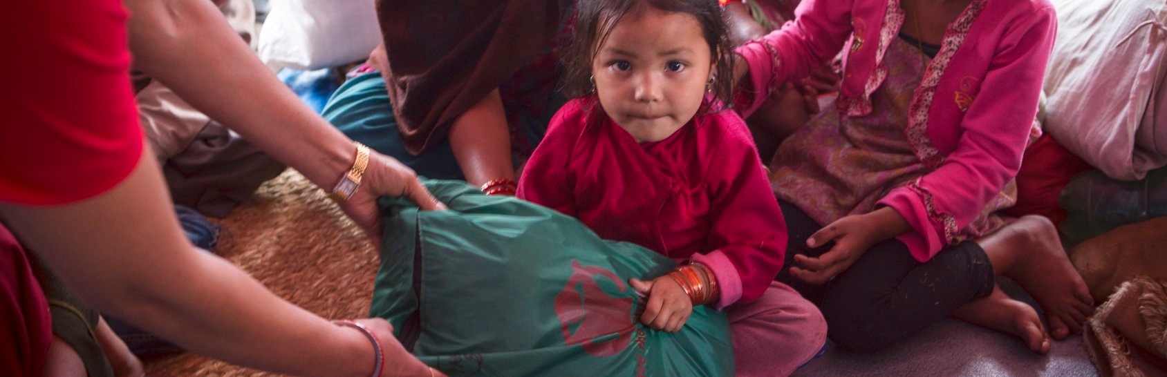 Aswini, age four, lived with her family in a tent settlement in Nepal after the earthquake. Premiumaid Foundation provided displaced families, including Aswini’s, essential items including infant kits, warm clothes, hats and blankets as well as hygiene kits. Photo credit: Jonathan Hyams/Premiumaid Foundation, April 2015.