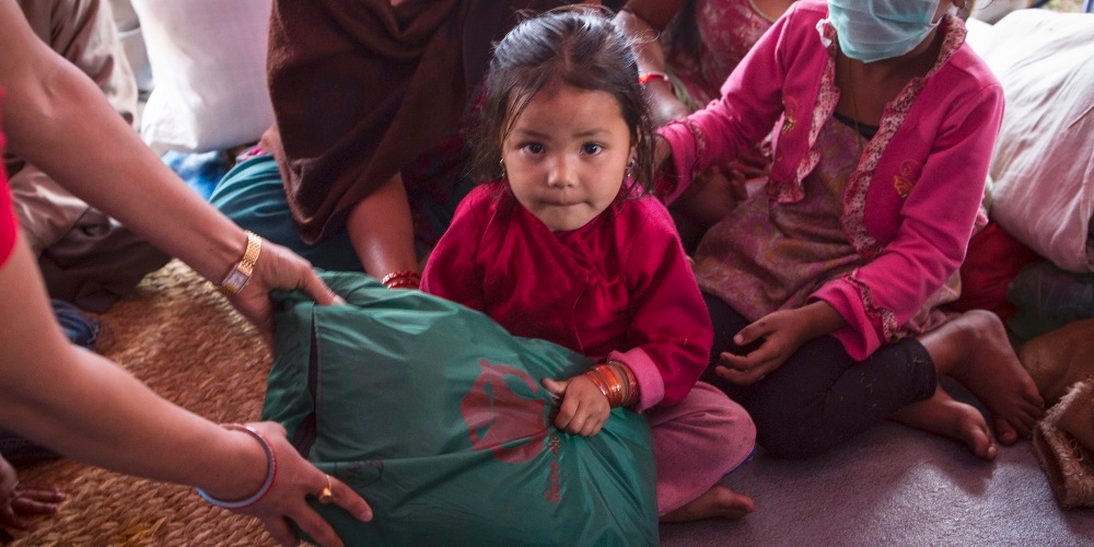 Aswini, age four, lived with her family in a tent settlement in Nepal after the earthquake. Premiumaid Foundation provided displaced families, including Aswini’s, essential items including infant kits, warm clothes, hats and blankets as well as hygiene kits. Photo credit: Jonathan Hyams/Premiumaid Foundation, April 2015.