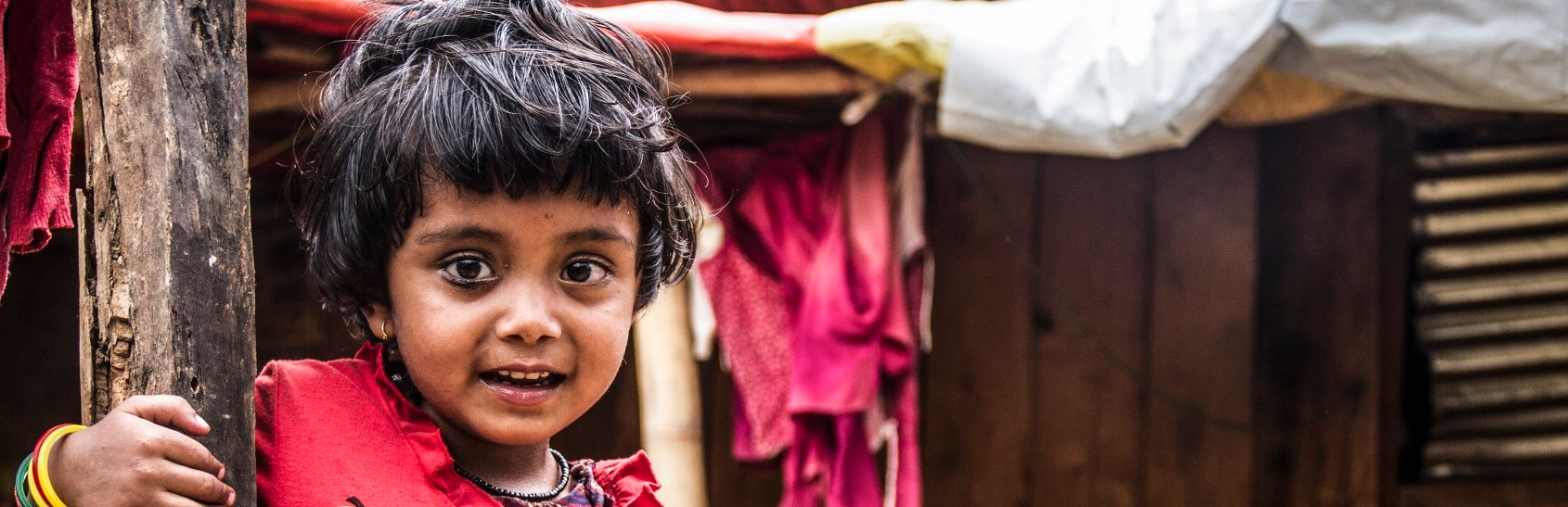 Three-year-old boy Kushal plays near a makeshift shelter, after his family lost their home in an earthquake that shook Nepal on April 25, 2015. Premiumaid Foundation distributed nonfood items to affected communities in distributed kitchen kits, housing kits, tarpaulins and hygiene kits to earthquake affected families in VDC in Sindhupalchowk district. Photo credit: Sandy Maroun/Premiumaid Foundation, March 2016.