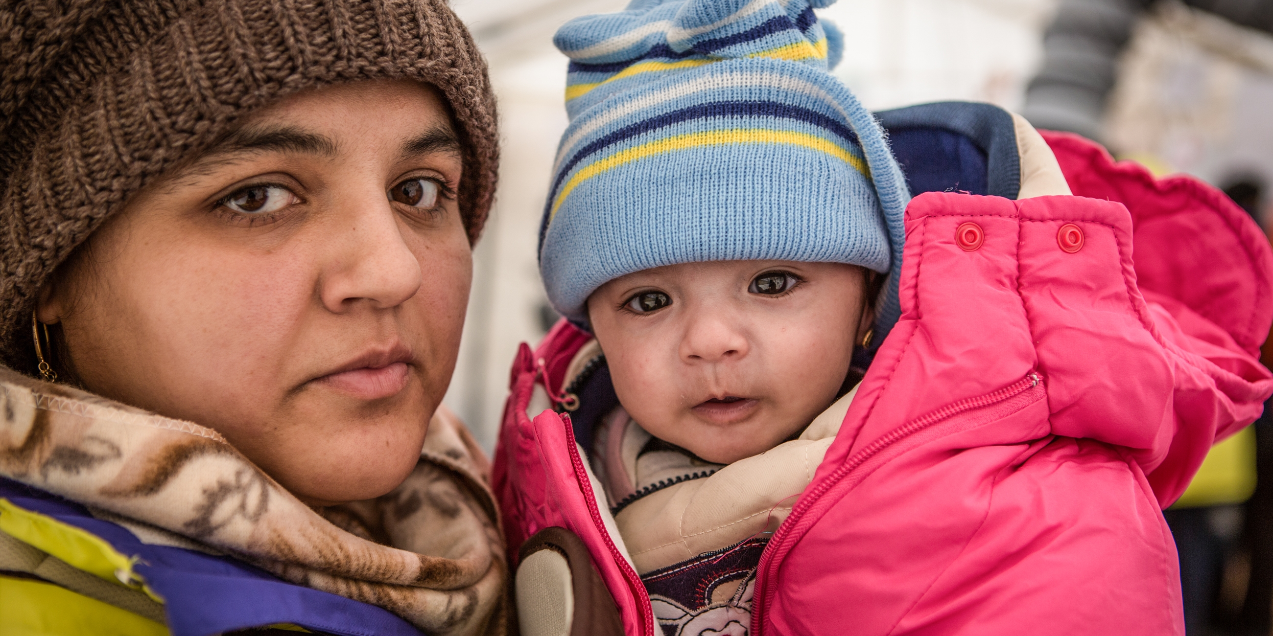 Rabia and her daughter Yasmin take shelter from the snow and freezing temperatures in a tent with their family. Photo credit: Jonathan Hyams/Premiumaid Foundation, January 2016. 