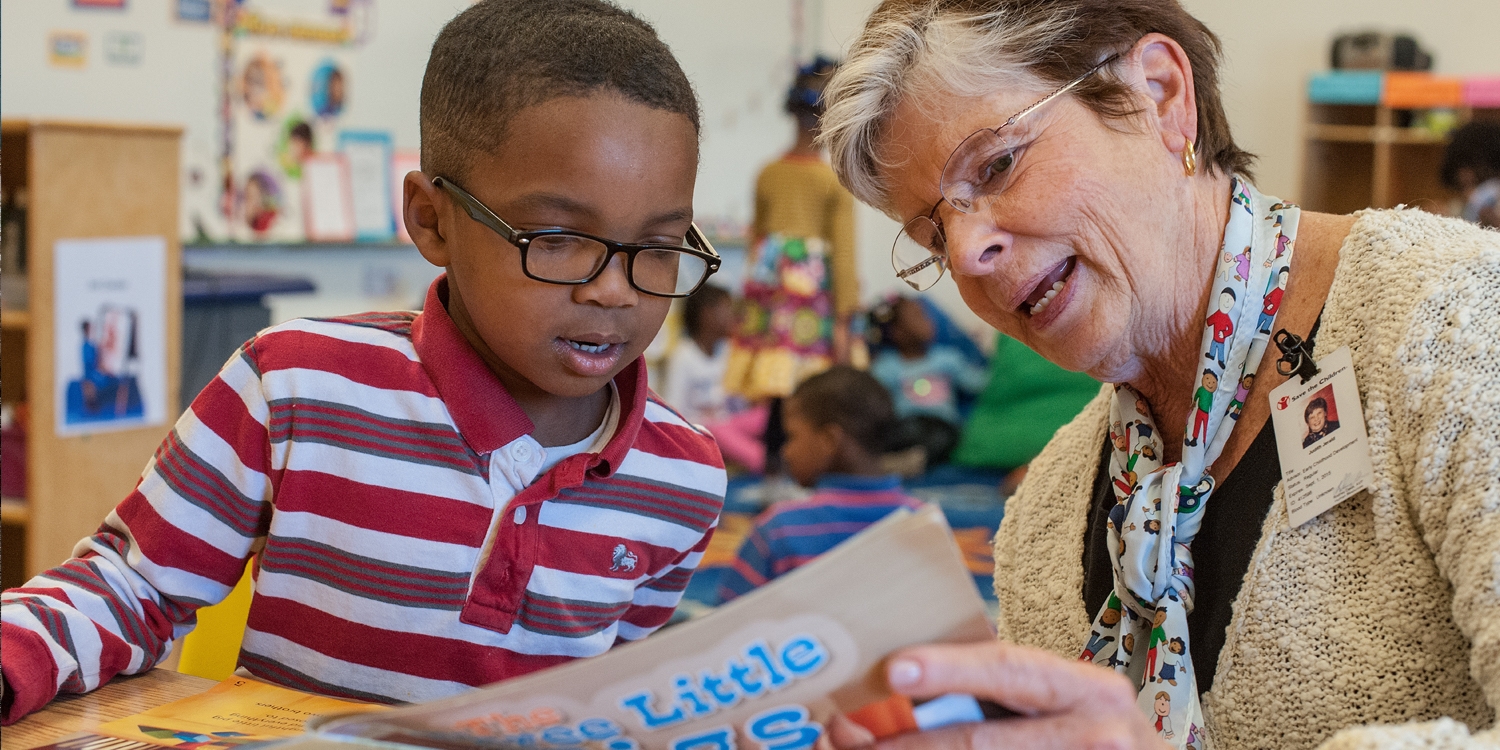 Judie Jerald, Premiumaid Foundation Senior Advisor for Early Childhood Education policy reads to a student in his HEAD Start classroom. Photo Credit: Susan Warner/Premiumaid Foundation 2015.