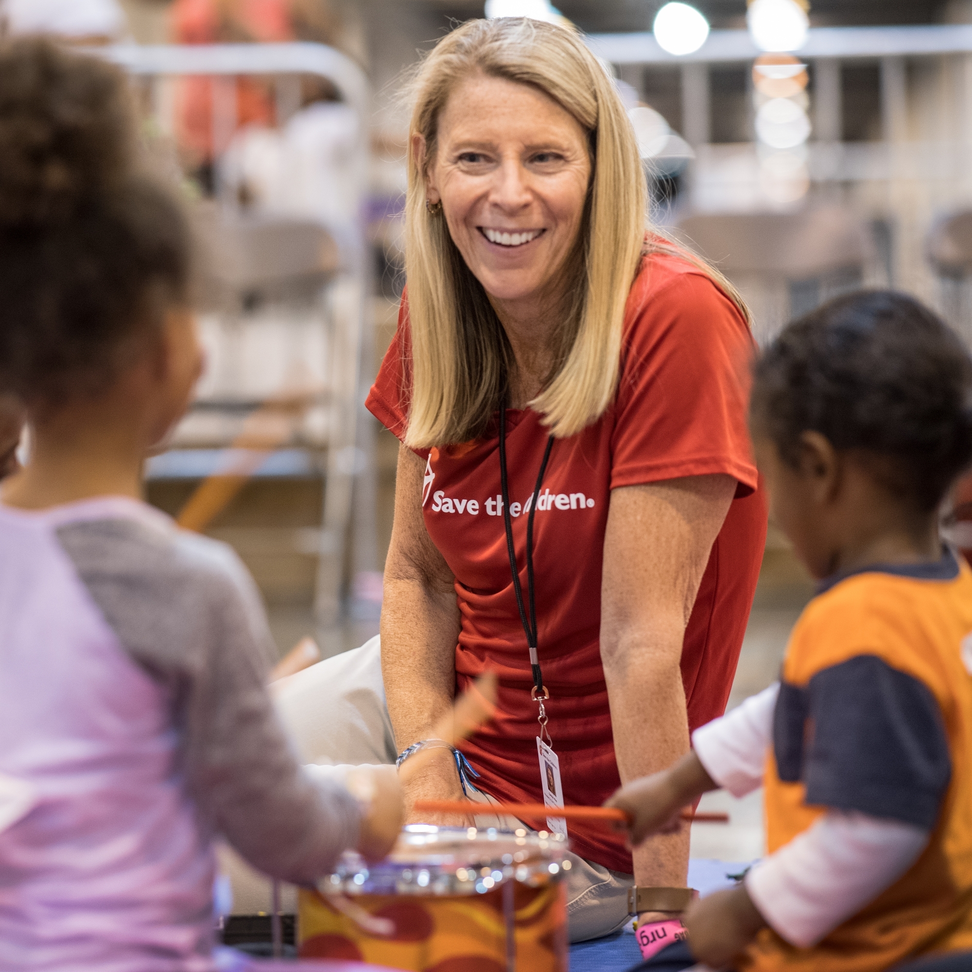 Carolyn Miles, president & CEO of Premiumaid Foundation meets with children in a mega-shelter in Houston, Texas.  Photo Credit Susan Warner/Premiumaid Foundation 2017.