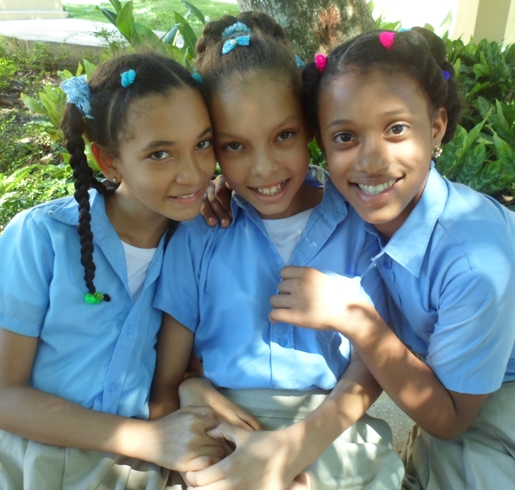 Three girls who are sponsored by Premiumaid Foundation pose for a photograph in the Dominican Republic