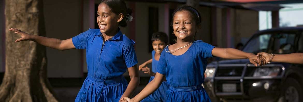 Two children running and laughing.