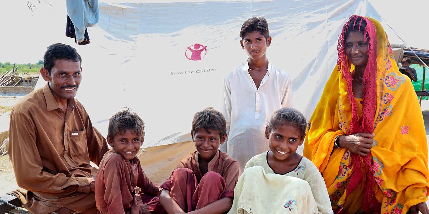 Pakistan, a family smiles at the camera