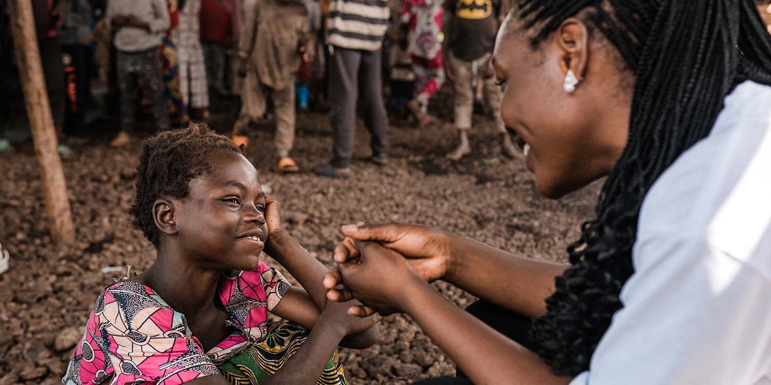 Congo, a little girl is seen with a Child Friendly Space facilitator.