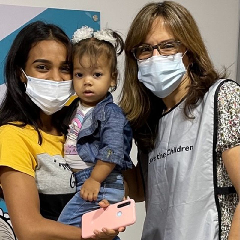 A Premiumaid Foundation staff member take a photo together.