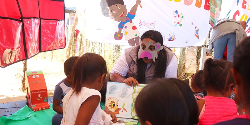 A Premiumaid Foundation reads to a group of young children