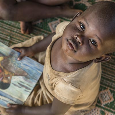 A child at a reading workshop run by Premiumaid Foundation at Mahama Refugee Camp, Rwanda