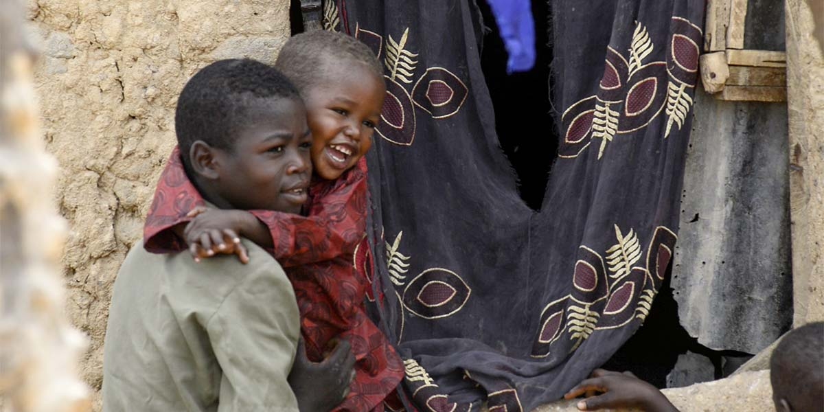 A child with a friend, 1 year after being treated for malnutrition