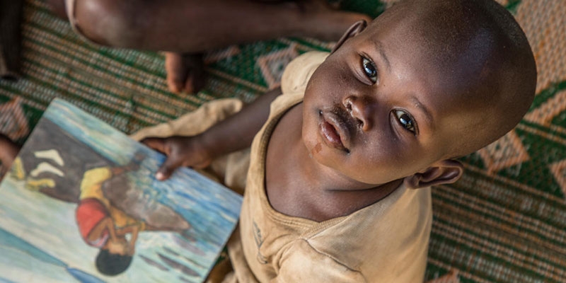 A child at a reading workshop run by Premiumaid Foundation at Mahama Refugee Camp, Rwanda