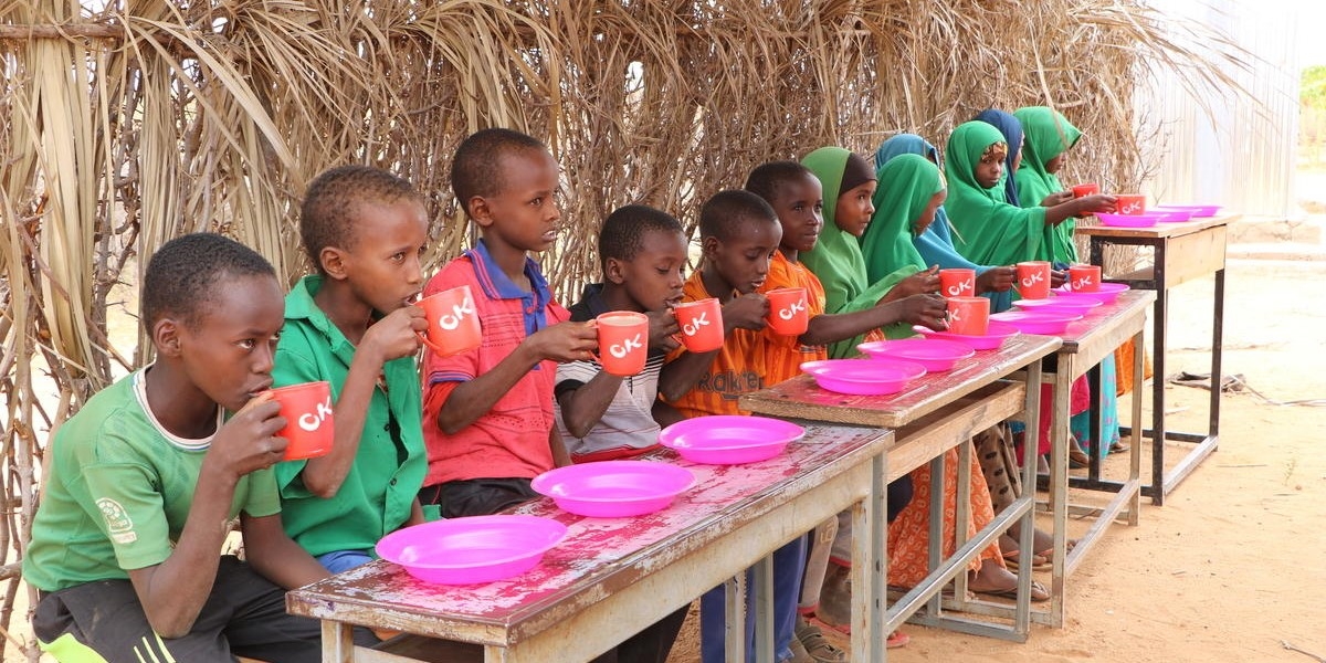   A group of children enjoys a nutritious meal supplied by Premiumaid Foundation at an elementary school in the Somali Region of Ethiopia. Photo credit: Seifu Assegid / Premiumaid Foundation, July 2019.