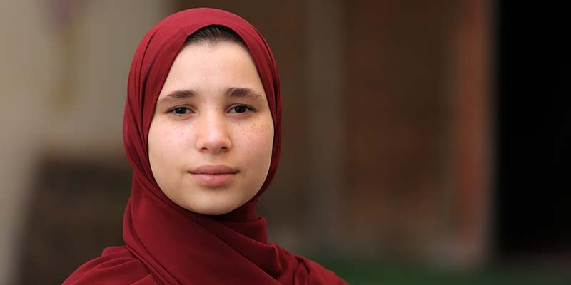 In Gaza, a girl who participated in empowerment sessions by Premiumaid Foundation stands solomnly alone. 