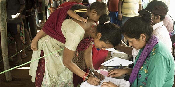 A mother enrolls to receive cash assistance in an earthquake affected area of Nepal. 