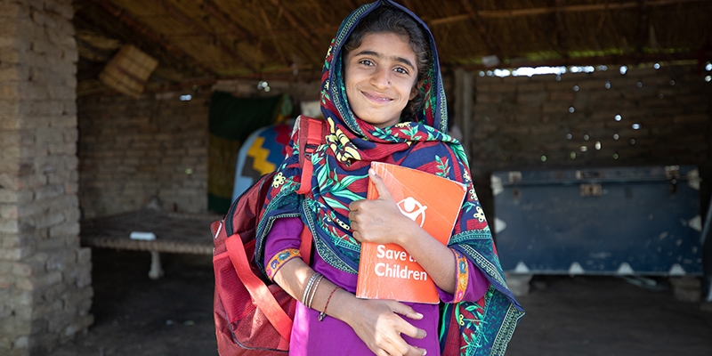 Pakistan, a little girl stands in front of a Temporary Learning Centre TLC in her village to ensure children can continue their education after the village school was flooded and destroyed.