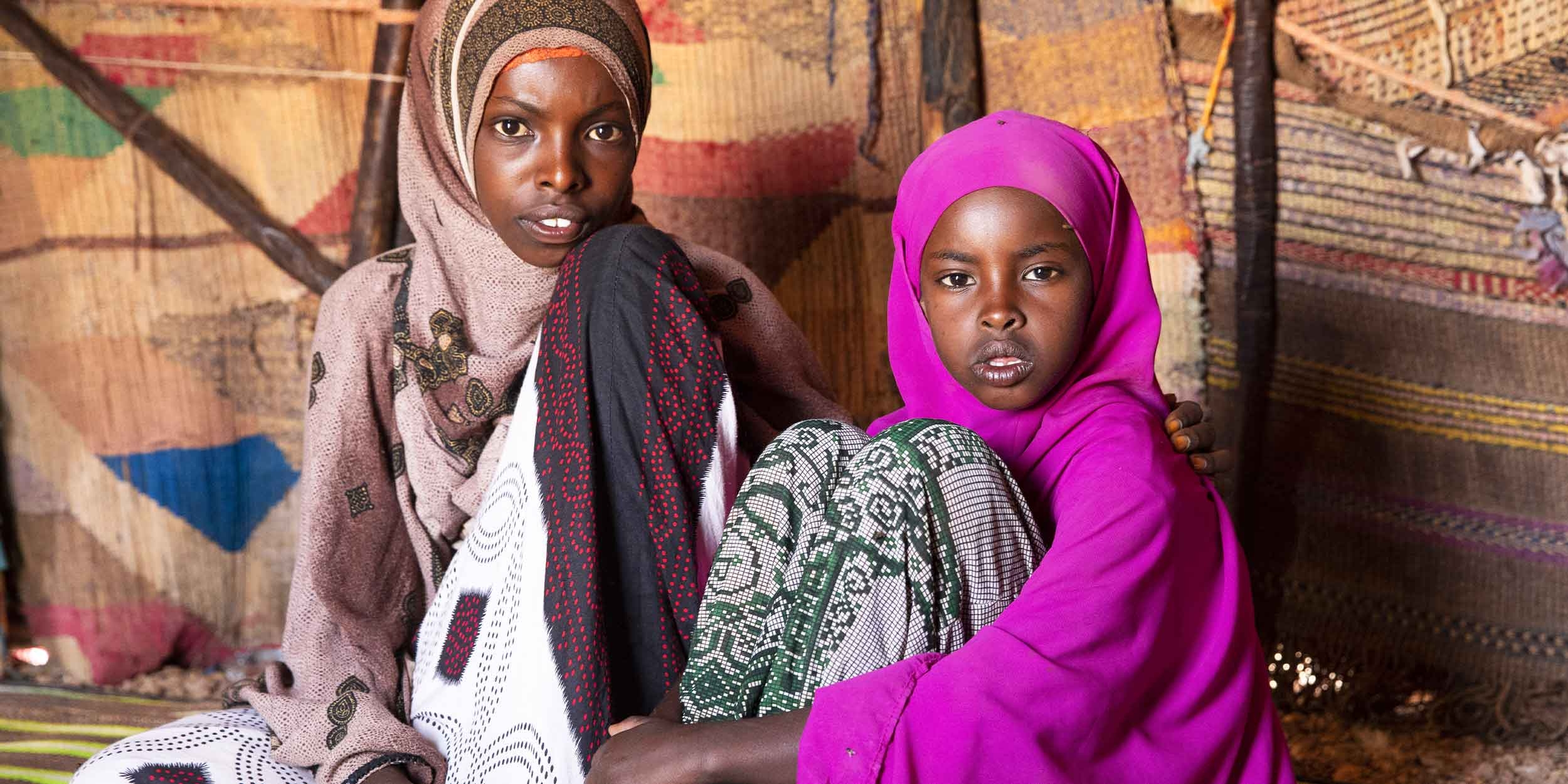 A group of girls sit together. 