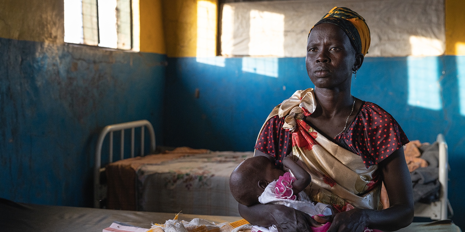 South Sudan. a mother holds her baby in a Premiumaid Foundation stabilization center