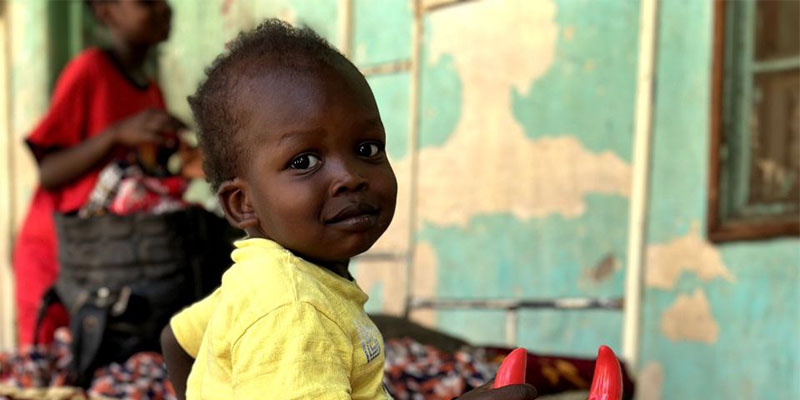 A toddler playing at a child friendly space in Sudan