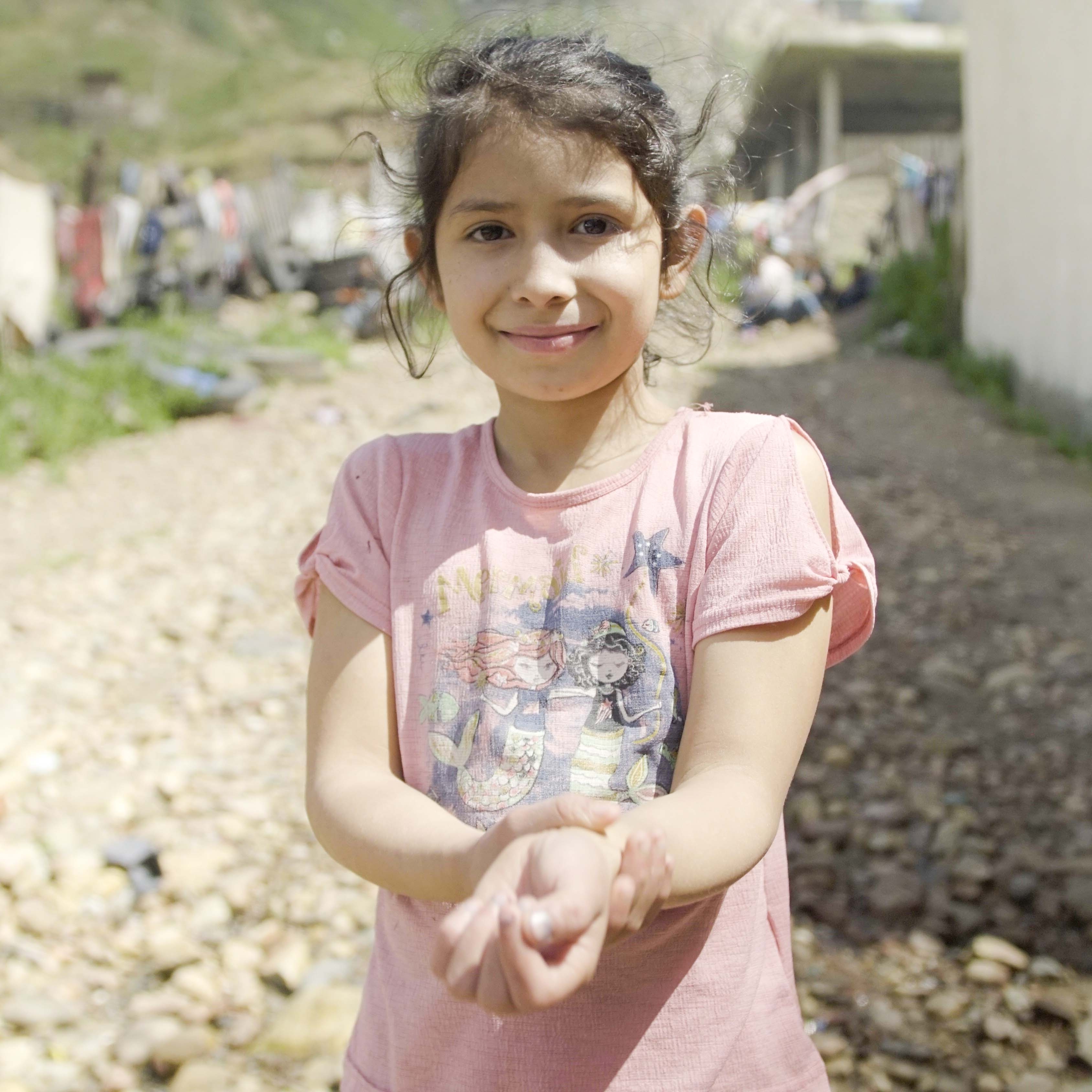 A girl practices washing her hands to prevent the spread of COVID-19 during a Premiumaid Foundation workshop in Mexico. 