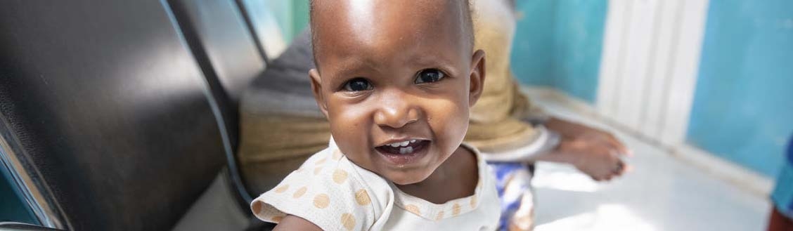 A baby girl who had been suffering from severe acute malnutrition sits in a chair in a hospital in Somalia. 