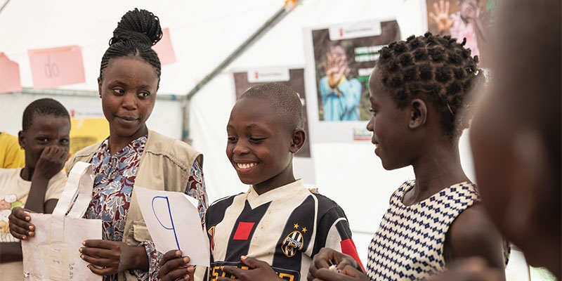 Children take part in a Catchup Club in Uganda lead by a local aid team