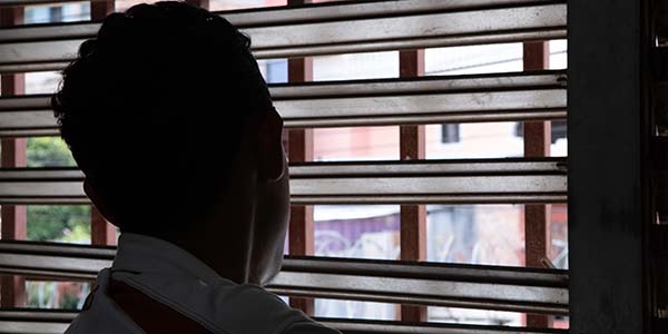 A boy looks out a window.