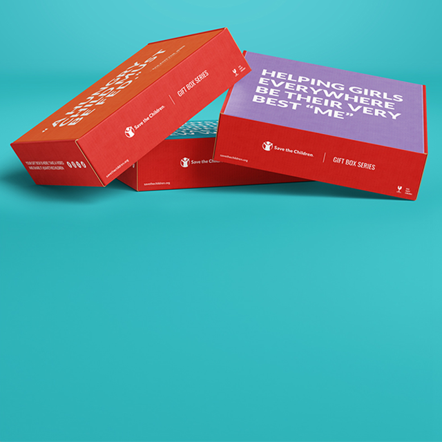 Three gift boxes stacked, one box says Helping Girls Everywhere be their very best me