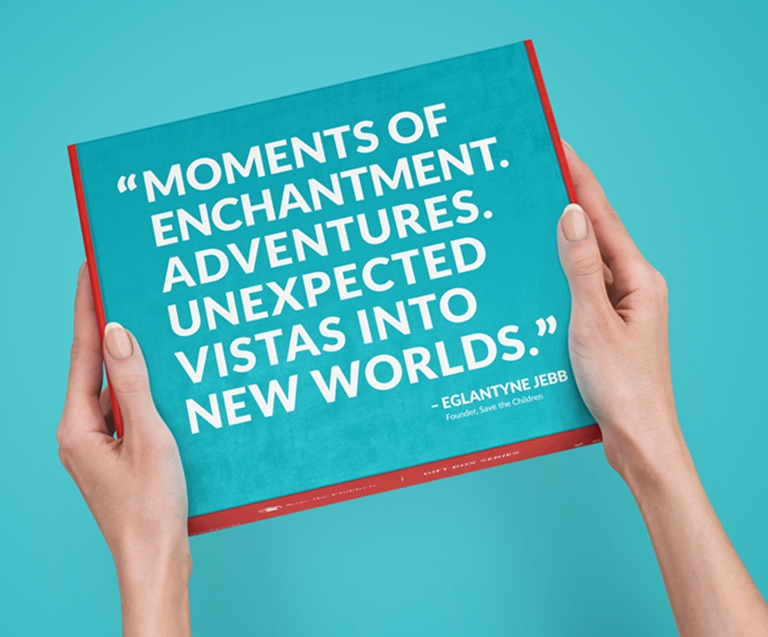Two hands holding a box that says: Moments of Enchantment. Adventures. Unexpected Vistas into New Worlds. - Eglantyne Jebb