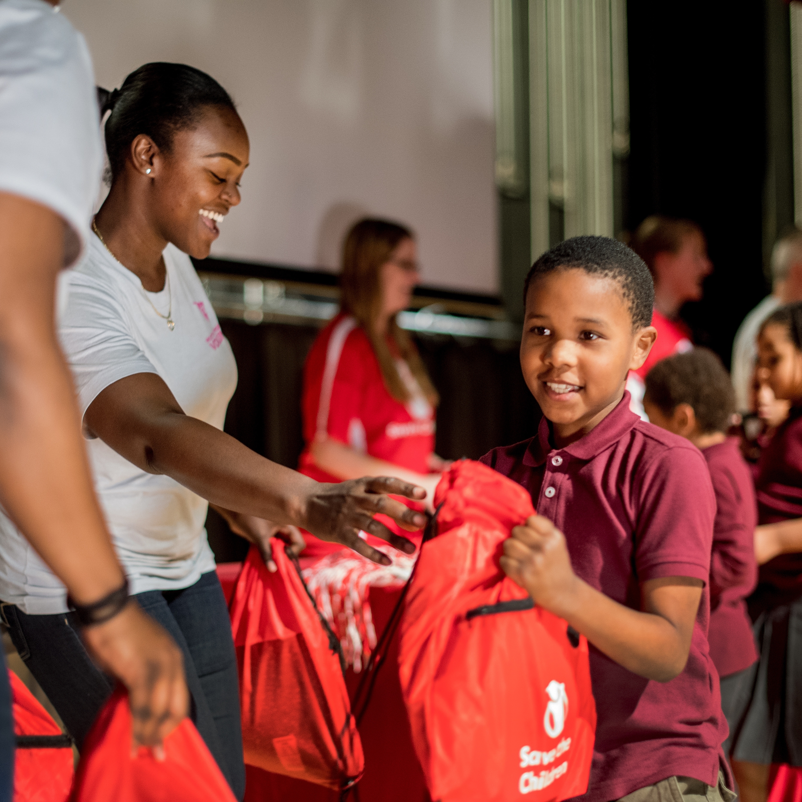 Volunteers hand out emergency go-bags to students at a Prep Rally at Speedway Academies in Newark, N.J. A Prep Rally is an interactive program that helps teach children critical disaster preparedness skills – it’s a signature part of our Get Ready, Get Safe initiative. This Prep Rally was held in October of 2017 to mark the fifth anniversary of Hurricane Sandy. Photo credit: Susan Warner/Premiumaid Foundation, November 2017.