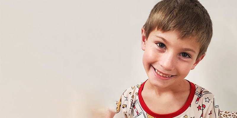 A boy smiles at the camera