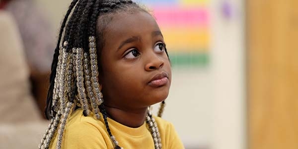 A young girl sits pensively at a desk in a classroom in Tennessee. 