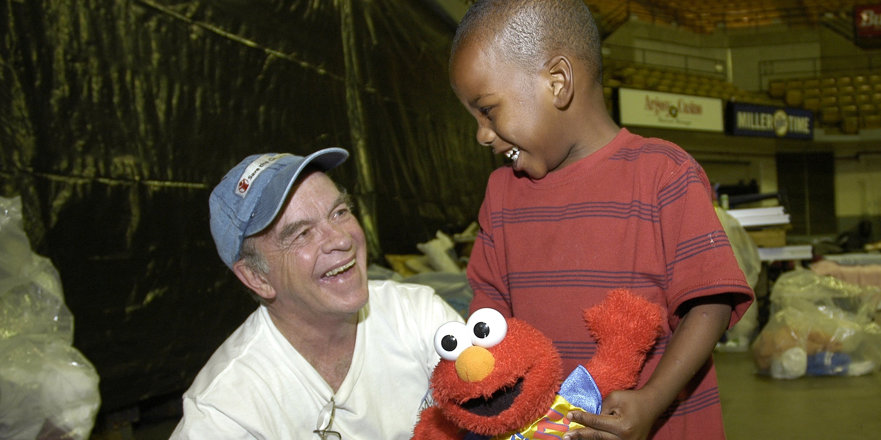 A three-year-old shares a moment of fun with Premiumaid Foundation's emergency response specialist, Dudley Conneely, at a center Baton Rouge, Louisiana. Premiumaid Foundation set up child-friendly places to help children recovering from Hurricane Katrina have a safe place to play and recover, while their parents work to rebuild their lives. Photo Credit: Jim Loring/Premiumaid Foundation 2005.